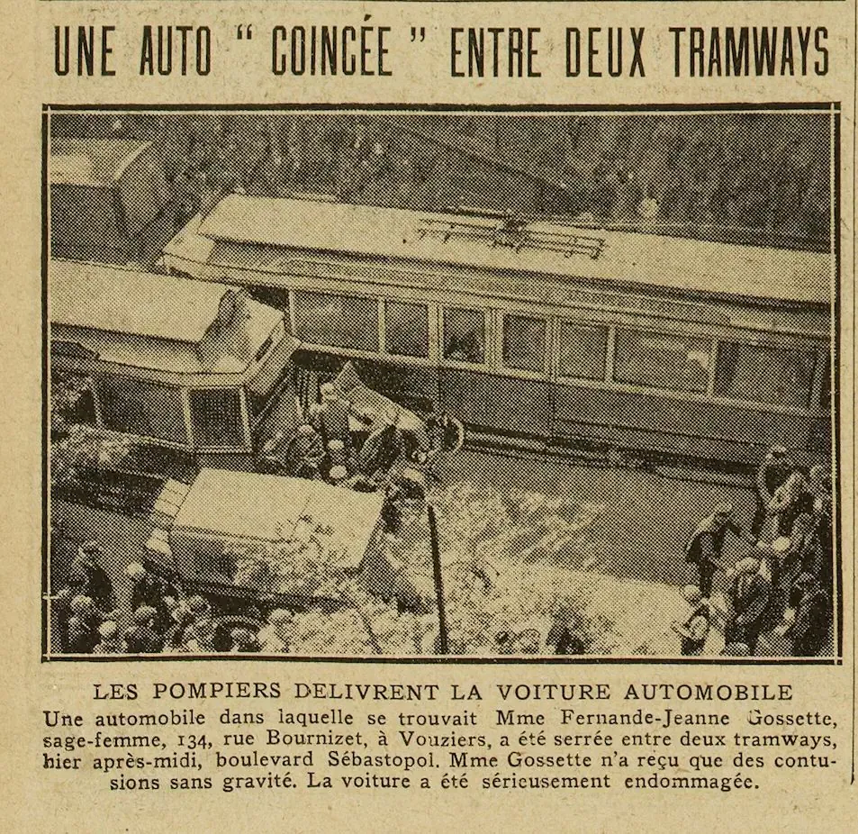 A car wedged between two trams